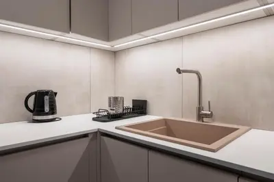 a kitchen with a sink and a coffee maker at Oculus Gelonos 1 BD City Apartment by Live&Travel in Athens