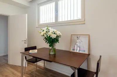 a vase of flowers on a table in a room at Holodek Apartments : Akropolis in Athens