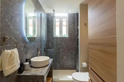 a bathroom with a sink and a mirror at Holodek Apartments : Akropolis in Athens