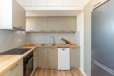 a kitchen with white cabinets and a white refrigerator at Holodek Apartments : Akropolis in Athens