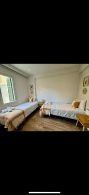 a bedroom with two beds and a window at Holodek Apartments : Akropolis in Athens