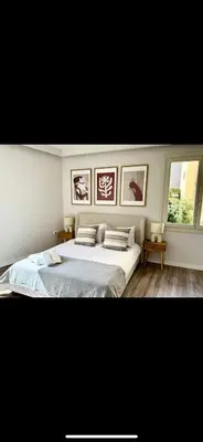 a bedroom with a large bed and two windows at Holodek Apartments : Akropolis in Athens
