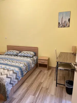 a bedroom with a bed and a desk and a table at Star Hostel in Piraeus