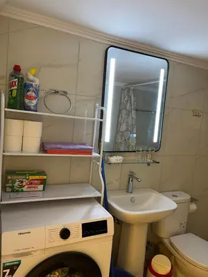 a small bathroom with a sink and a washing machine at Star Hostel in Piraeus