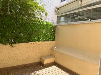 a stairway next to a building with a hedge at Star Hostel in Piraeus