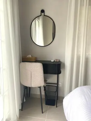 a black desk with a chair and a mirror at Arcus by Aestas Suites in Artemida