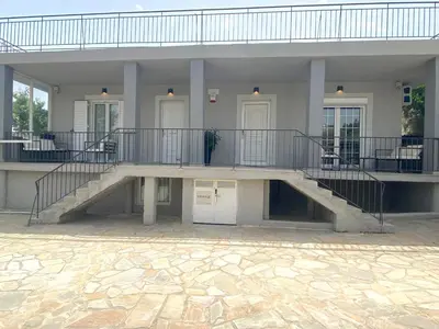 a large building with a staircase in front of it at Arcus by Aestas Suites in Artemida