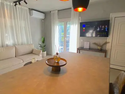 a living room with a table and a couch at Arcus by Aestas Suites in Artemida