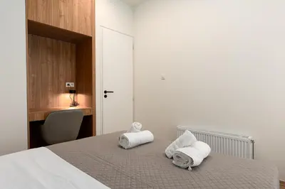 a bedroom with a bed with towels on it at Serene 1BR Apartment in the Heart of Athens in Athens