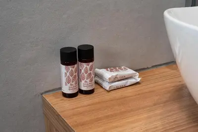 two bottles ofodorizers sitting on a table next to a sink at Serene 1BR Apartment in the Heart of Athens in Athens