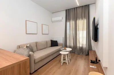 a living room with a couch and a table at Serene 1BR Apartment in the Heart of Athens in Athens
