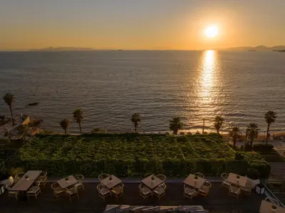 a view of the ocean from the resort at sunset at Coral Three-Bedroom Apartments with Sea View and Balcony in Athens