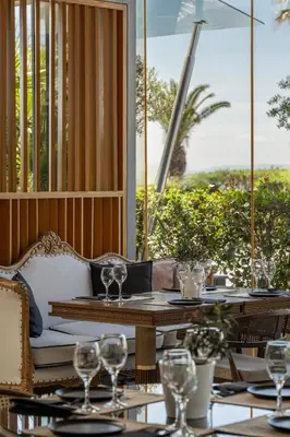 a table with wine glasses on a patio at Coral Three-Bedroom Apartments with Sea View and Balcony in Athens