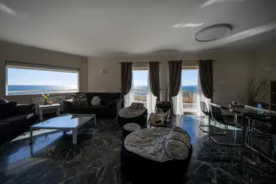 a living room with a couch and a table at Coral Three-Bedroom Apartments with Sea View and Balcony in Athens