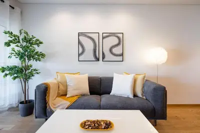 a living room with a couch and a table at Bloom - Luxury 2-Bedroom Apartment in Athens in Athens