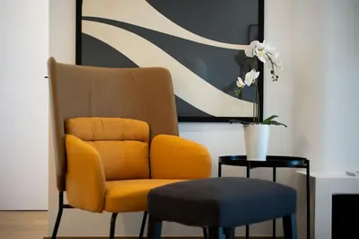 a yellow chair and a stool in a room at Bloom - Luxury 2-Bedroom Apartment in Athens in Athens