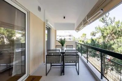a balcony with a table and chairs on it at Bloom - Luxury 2-Bedroom Apartment in Athens in Athens