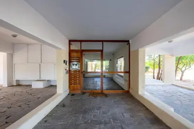 an empty hallway of a house with a wooden door at Bloom - Luxury 2-Bedroom Apartment in Athens in Athens