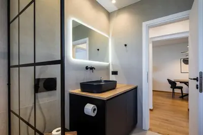 a bathroom with a sink and a mirror at Bloom - Luxury 2-Bedroom Apartment in Athens in Athens