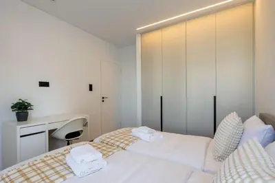 a bedroom with a bed with a desk and a chair at Bloom - Luxury 2-Bedroom Apartment in Athens in Athens