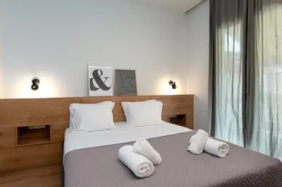 a bedroom with two white towels on a bed at Calm 1BR Apartment in the Heart of Athens in Athens
