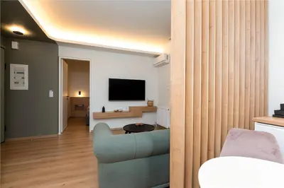 a living room with a couch and a television at Calm 1BR Apartment in the Heart of Athens in Athens
