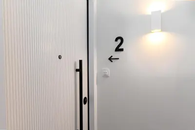 a clock on a wall next to a door at Calm 1BR Apartment in the Heart of Athens in Athens