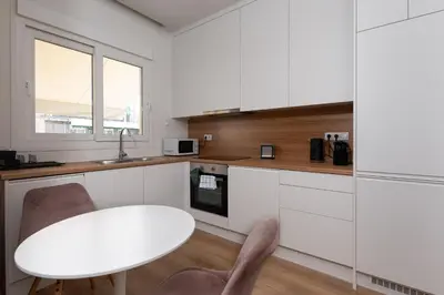 a kitchen with a white table and a white counter top at Calm 1BR Apartment in the Heart of Athens in Athens