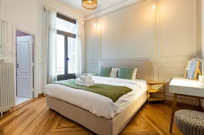 a bedroom with a bed with a teddy bear on it at Meadows - Luxury 3-Bedroom Apartment in Athens in Athens