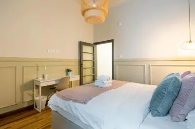 a bedroom with a bed with a desk and a sink at Meadows - Luxury 3-Bedroom Apartment in Athens in Athens