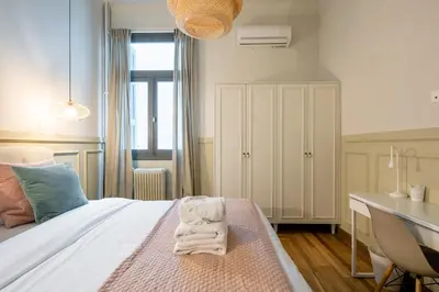 a bedroom with a bed with towels on it at Meadows - Luxury 3-Bedroom Apartment in Athens in Athens