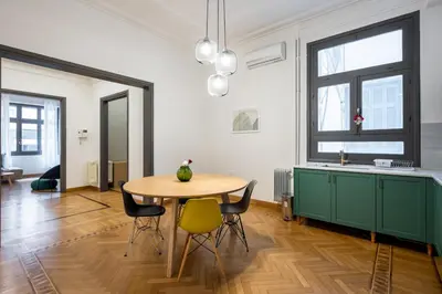 a kitchen with a table and chairs in a room at Meadows - Luxury 3-Bedroom Apartment in Athens in Athens