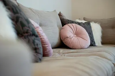 a couch with pillows and a pink pillow on it at Meadows - Luxury 3-Bedroom Apartment in Athens in Athens