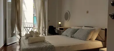 a bedroom with a bed with a view of a balcony at Magnolia Apartment -4BD , 1.5 BT in Athens