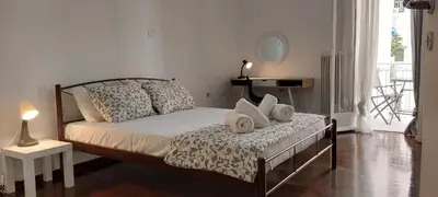 a bedroom with a bed with pillows on it at Magnolia Apartment -4BD , 1.5 BT in Athens