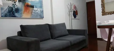 a couch in a living room with a painting on the wall at Magnolia Apartment -4BD , 1.5 BT in Athens
