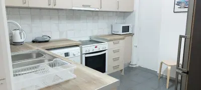 a kitchen with a sink and a stove top oven at Magnolia Apartment -4BD , 1.5 BT in Athens