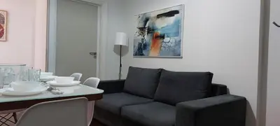 a living room with a couch and a table at Magnolia Apartment -4BD , 1.5 BT in Athens