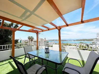 a patio with a table and chairs on a balcony at Riviera View in Athens