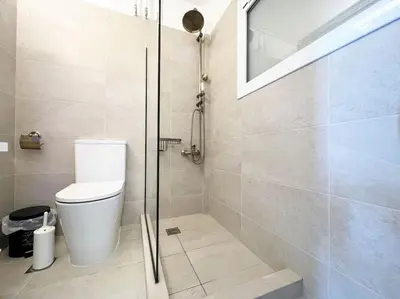 a bathroom with a toilet and a glass shower at Riviera View in Athens