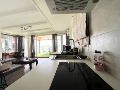 a kitchen with a sink and a living room at Riviera View in Athens