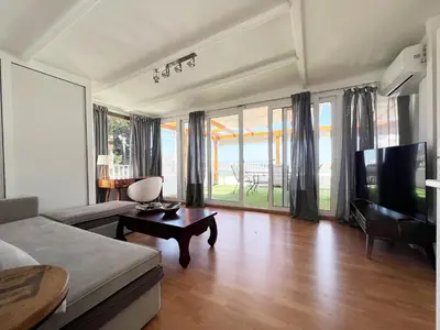 a living room with a couch and a tv at Riviera View in Athens