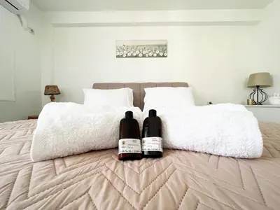 two bottles of wine sitting on top of a bed at Riviera View in Athens