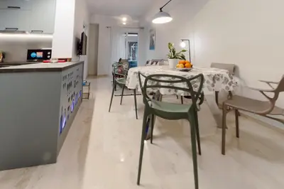 a kitchen and dining room with a table and chairs at Blue harbour house - style meets comfort in Piraeus
