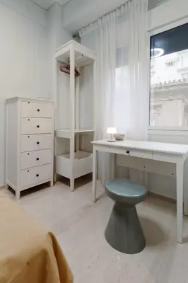 a bedroom with a desk and a bed and a window at Blue harbour house - style meets comfort in Piraeus