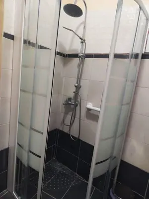 a shower in a bathroom with a glass door at Studio with unique view near the beach! in Porto Rafti