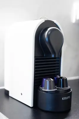 a black hair dryer on a counter next to a box at Luxury Beachfront Suite in Voula Premium 2-Bedroom Stay in Athens