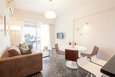 a living room with a couch and a table at Luxury Beachfront Suite in Voula Premium 2-Bedroom Stay in Athens