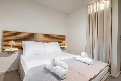 a bedroom with two towels on a bed at Atlantis Riviera Beachfront Fast WiFi in Athens