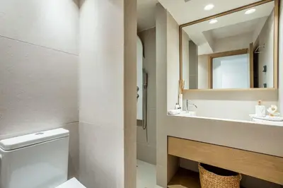 a bathroom with a toilet and a sink and a mirror at Atlantis Riviera Beachfront Fast WiFi in Athens